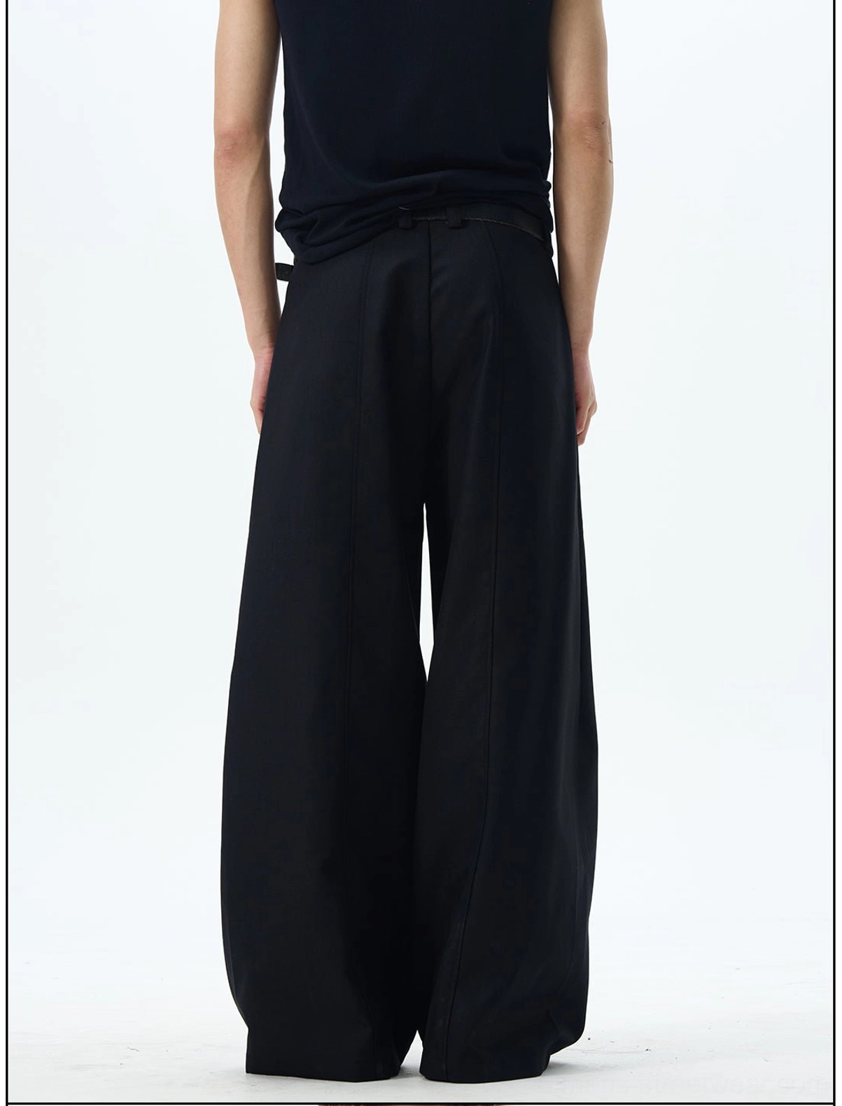 Back view of black wide-leg skater pants showing the clean waistband and flowing oversized trouser silhouette