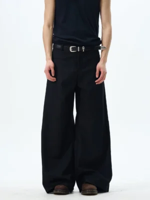 Front full-body view of black wide-leg skater pants with a high-rise waist, ultra-wide silhouette, matte finish, and black streetwear styling