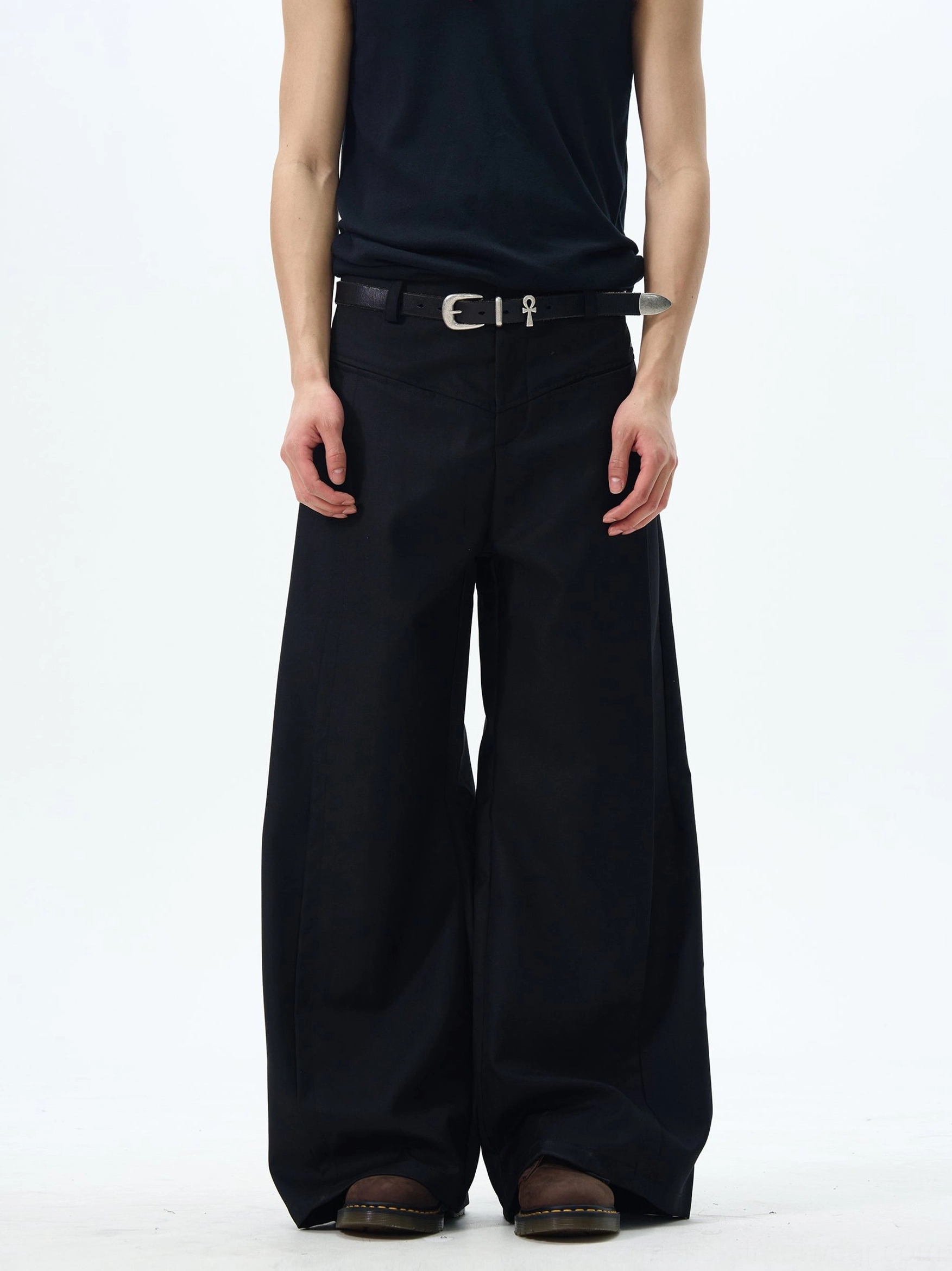 Front full-body view of black wide-leg skater pants with a high-rise waist, ultra-wide silhouette, matte finish, and black streetwear styling