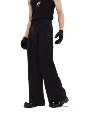 Black wide-leg tailored trousers shown from a three-quarter side view with high waist front pleats flowy silhouette and minimalist Seoul fashion styling