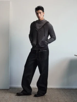 Black wide leg utility jeans with contrast stitching shown in a front three-quarter full-body streetwear outfit
