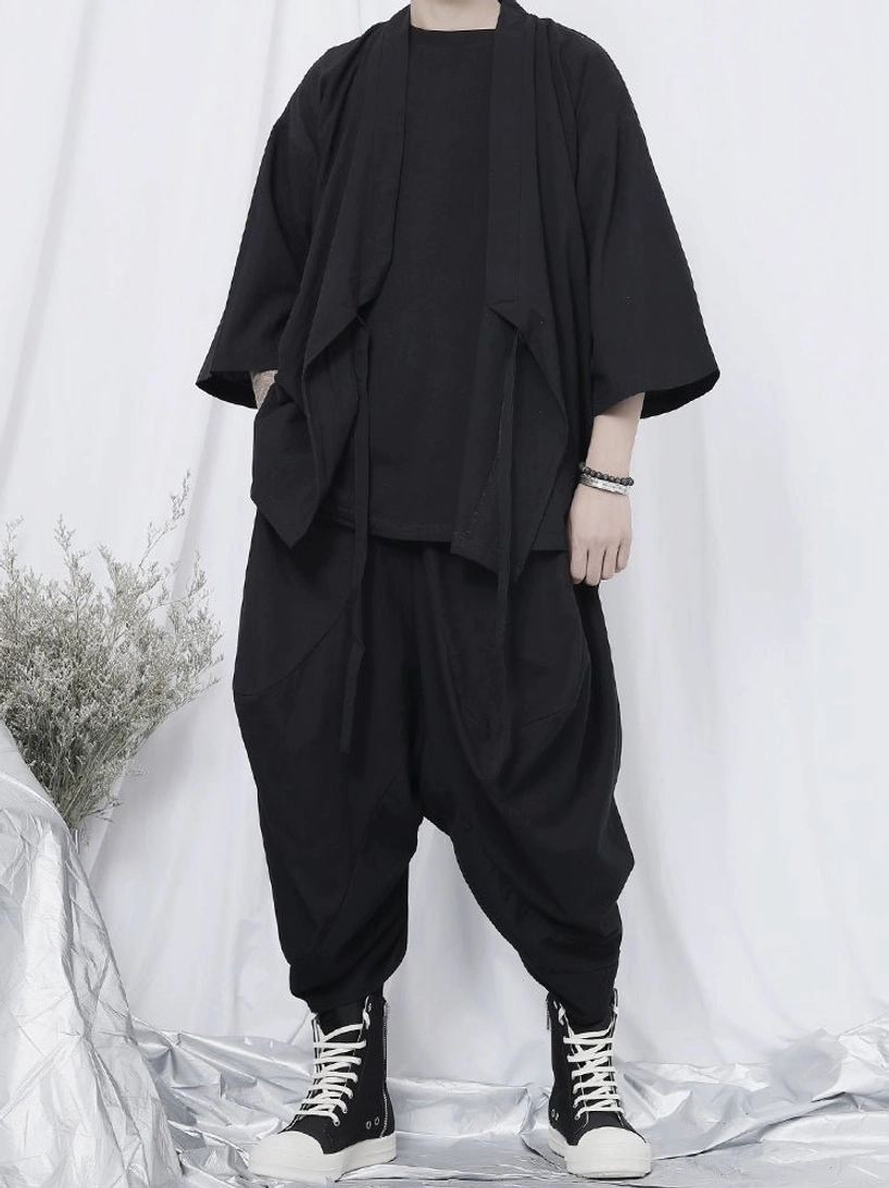 Black wrap kimono shirt in an oversized Korean streetwear outfit with wide sleeves, side tie straps, loose harem pants, and monochrome styling