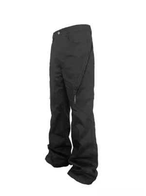 Black zip detail wide leg utility pants shown in left side three-quarter view with curved zipper pocket and stacked streetwear silhouette