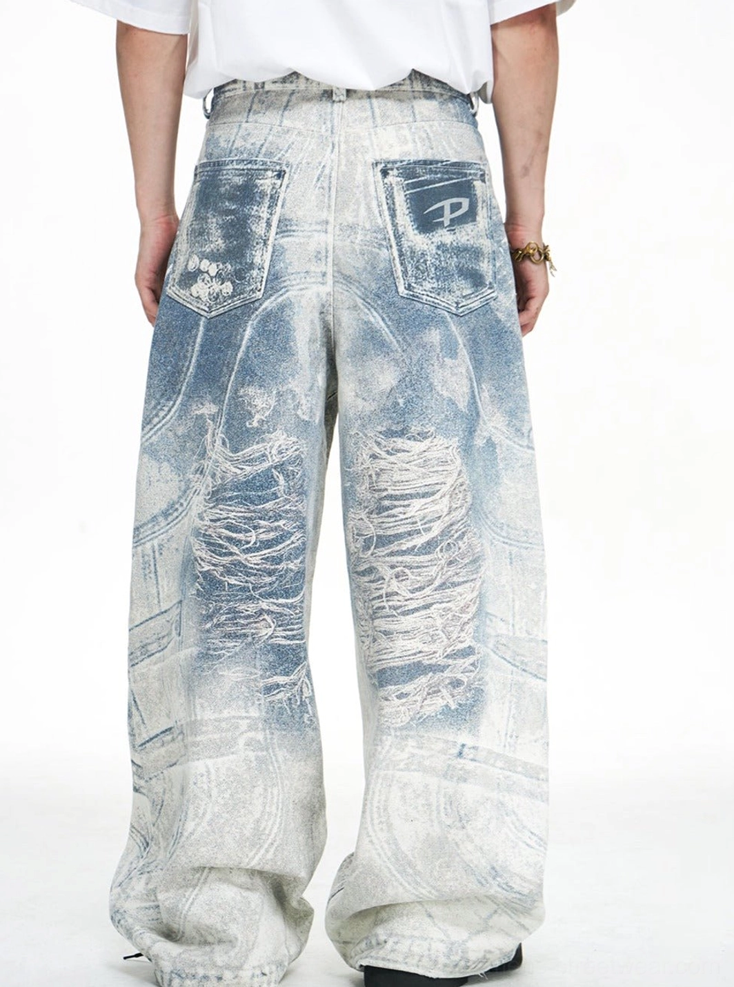 Rear view of blue acid-wash wide-leg baggy jeans showing back pockets and faded distressed denim finish