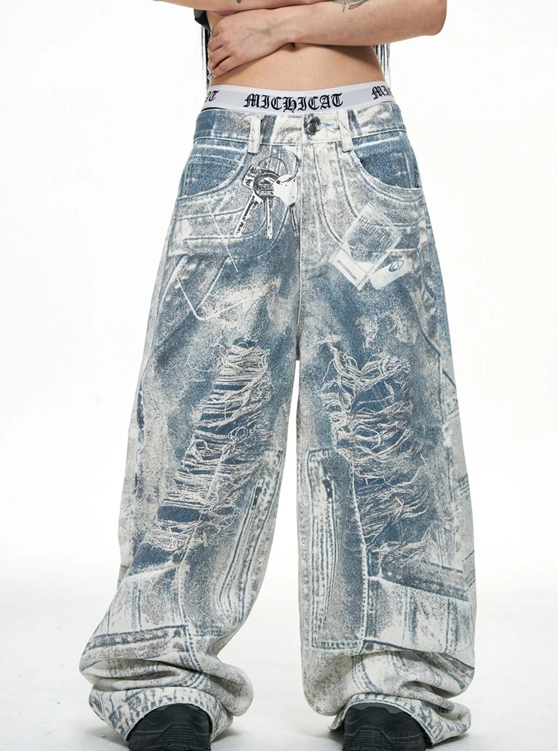 Front close view of blue acid-wash baggy jeans with faded distressed denim wash and wide-leg fit