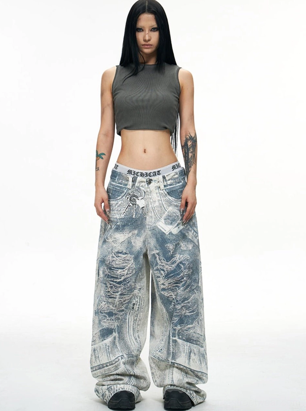 Full front view of blue acid-wash baggy jeans featuring extra-wide legs and long stacked hem