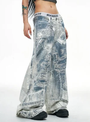 Blue acid-wash ultra wide-leg baggy jeans shown in left side view with oversized stacked denim silhouette