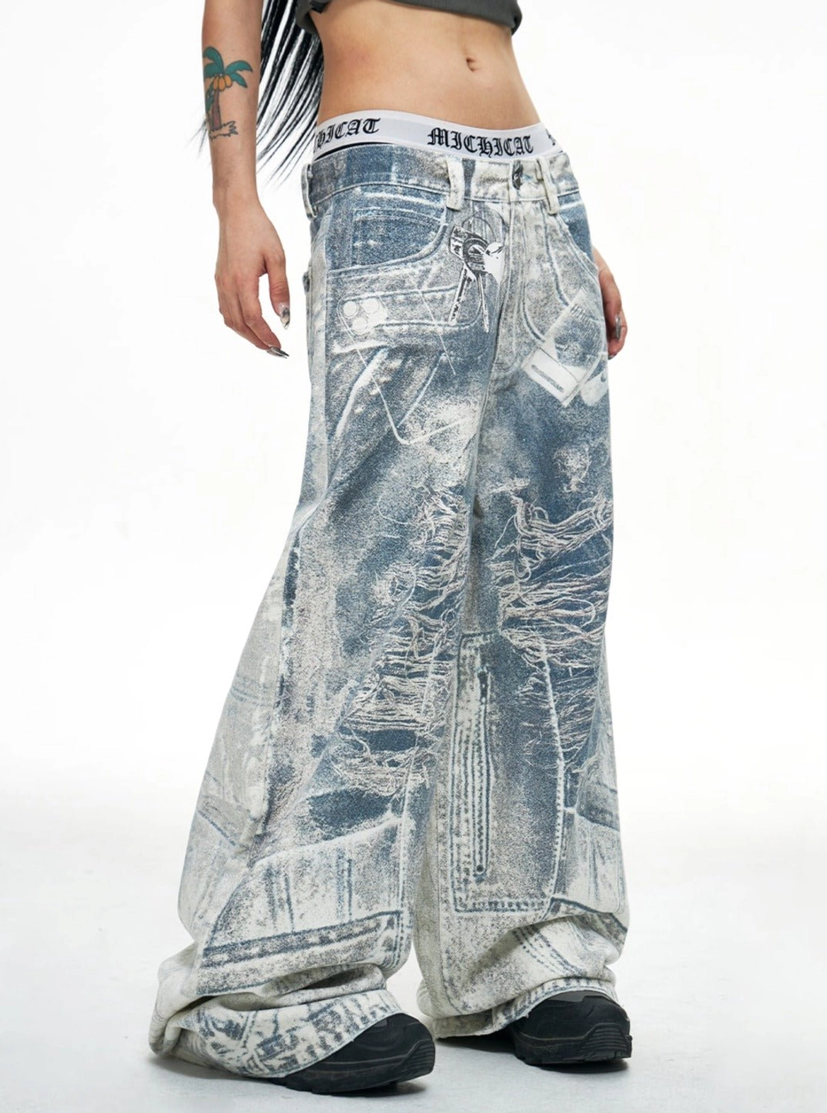 Blue acid-wash ultra wide-leg baggy jeans shown in left side view with oversized stacked denim silhouette