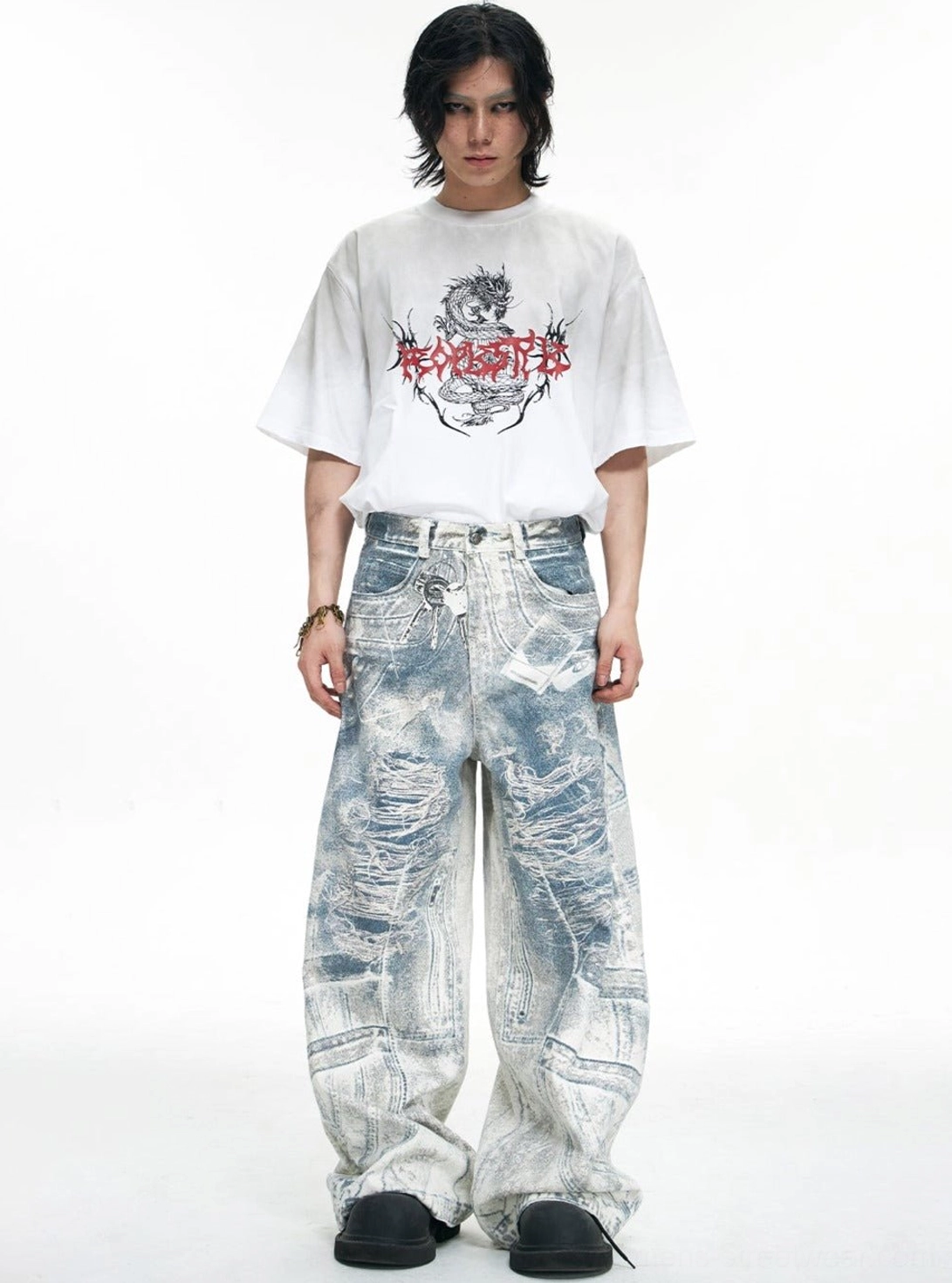 Blue acid-wash ultra wide-leg baggy jeans styled on male model with graphic T-shirt for streetwear outfit