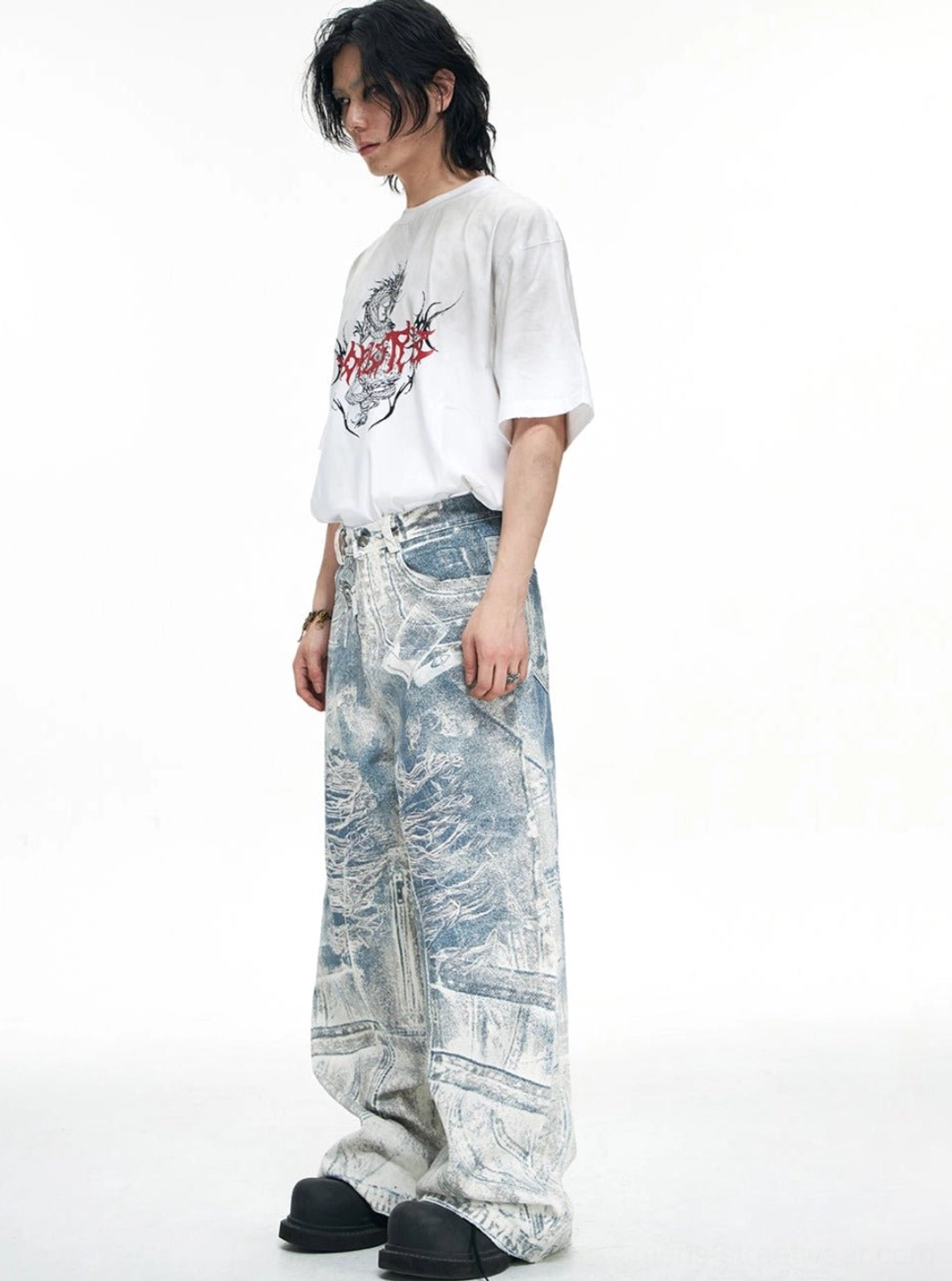 Three-quarter view of blue acid-wash baggy jeans on male model highlighting relaxed wide-leg stacked fit