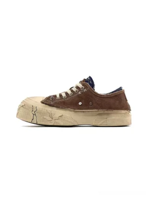 Blue brown distressed platform sneakers shown from the left side with a washed upper, weathered panels, white laces, and cracked off white platform sole