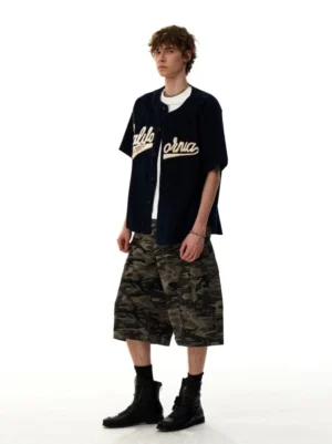 Blue corduroy California baseball shirt styled with a white undershirt camouflage cargo shorts and black boots