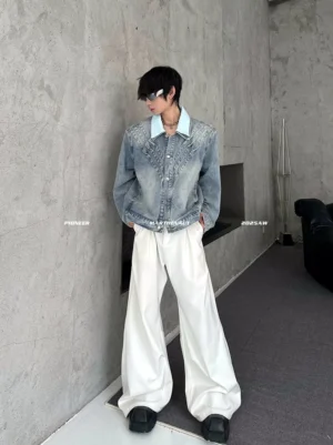 Side view of a relaxed vintage washed blue chevron denim jacket showing the contrast collar, roomy sleeves, oversized silhouette, and modern Korean streetwear styling