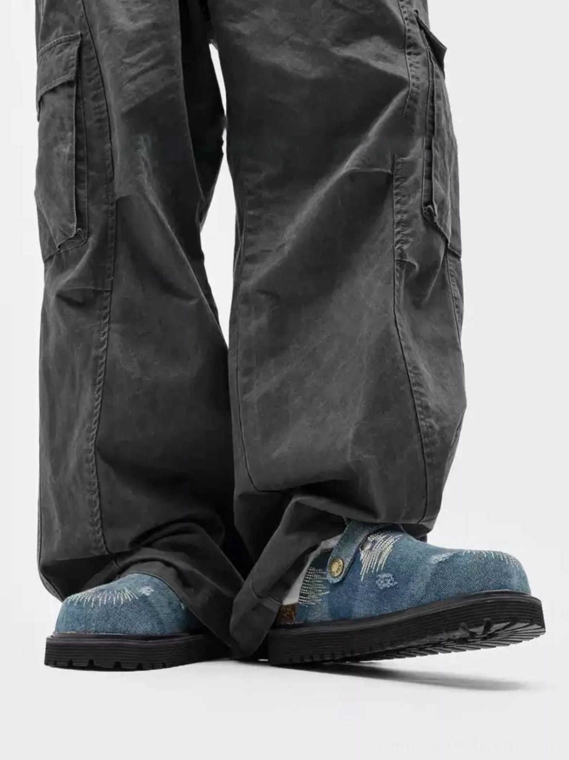 Side lower-body view of blue distressed denim platform mule clogs with frayed stitch details, slip-on construction and durable thick rubber soles