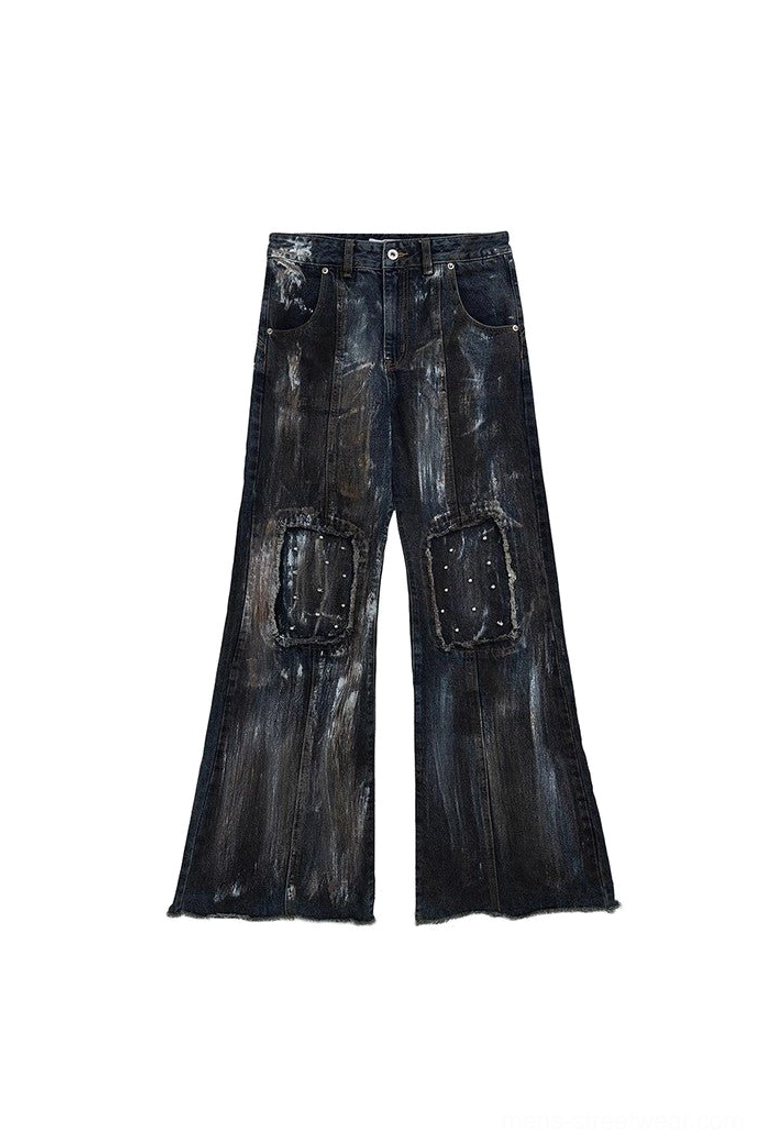 Blue vintage washed distressed wide-leg jeans flat lay front view with metal rivet knee patches and flared raw hems