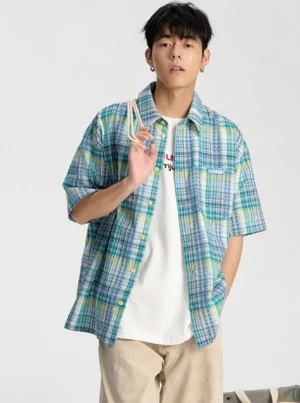 Blue embroidered checkerboard short sleeve shirt layered over a white tee in a relaxed Korean streetwear outfit