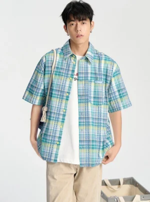 Blue embroidered checkerboard short sleeve streetwear shirt shown in a full front outfit view