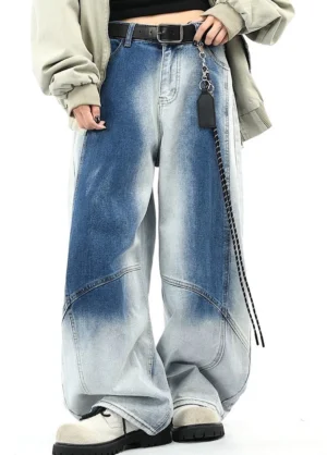 Three-quarter front view of blue two-tone faded wide-leg streetwear pants with relaxed fit and curved seams