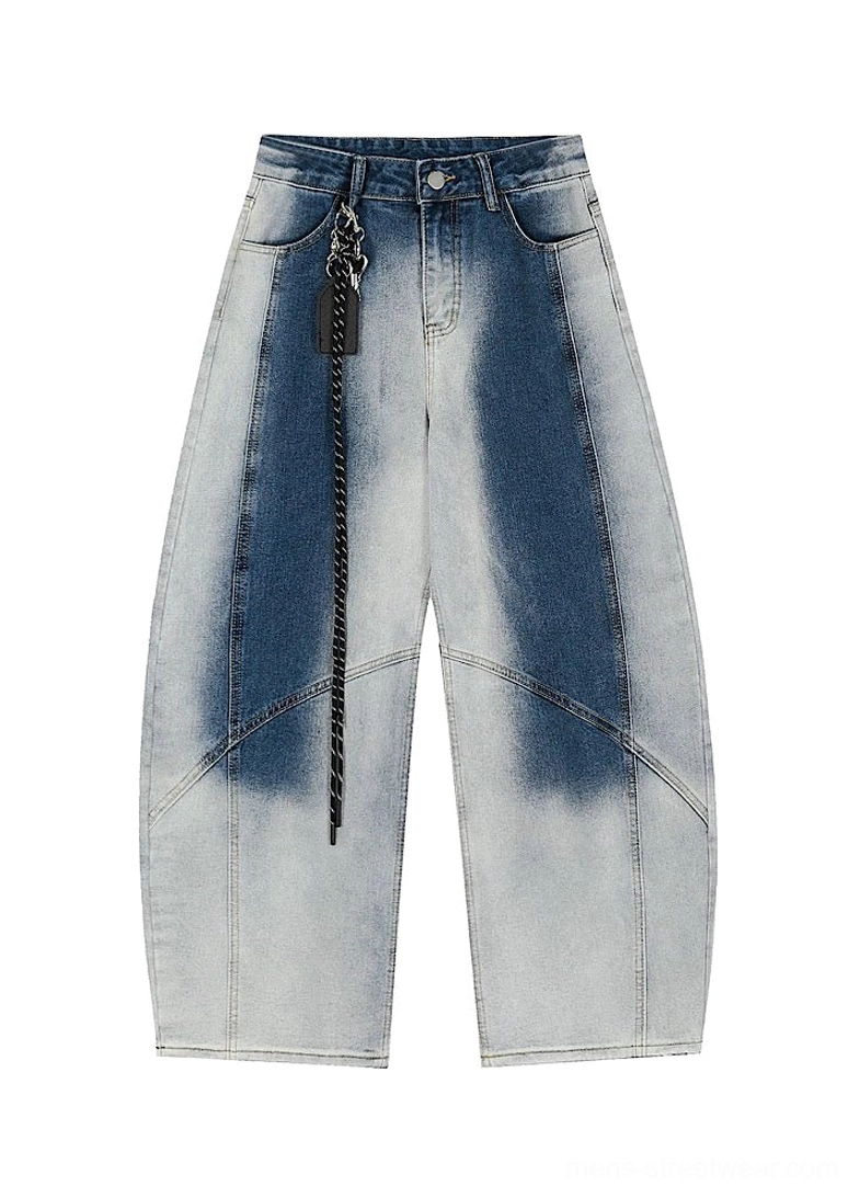 Flat lay front view of blue faded gradient wide-leg pants with waistband, button fly, curved seams, and chain accessory