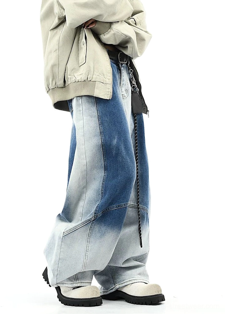 Side view of blue gradient wash wide-leg pants showing loose silhouette and curved side seam detailing