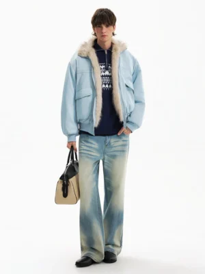 Full body view of blue oversized faux fur aviator jacket styled with navy knitwear and wide leg washed jeans