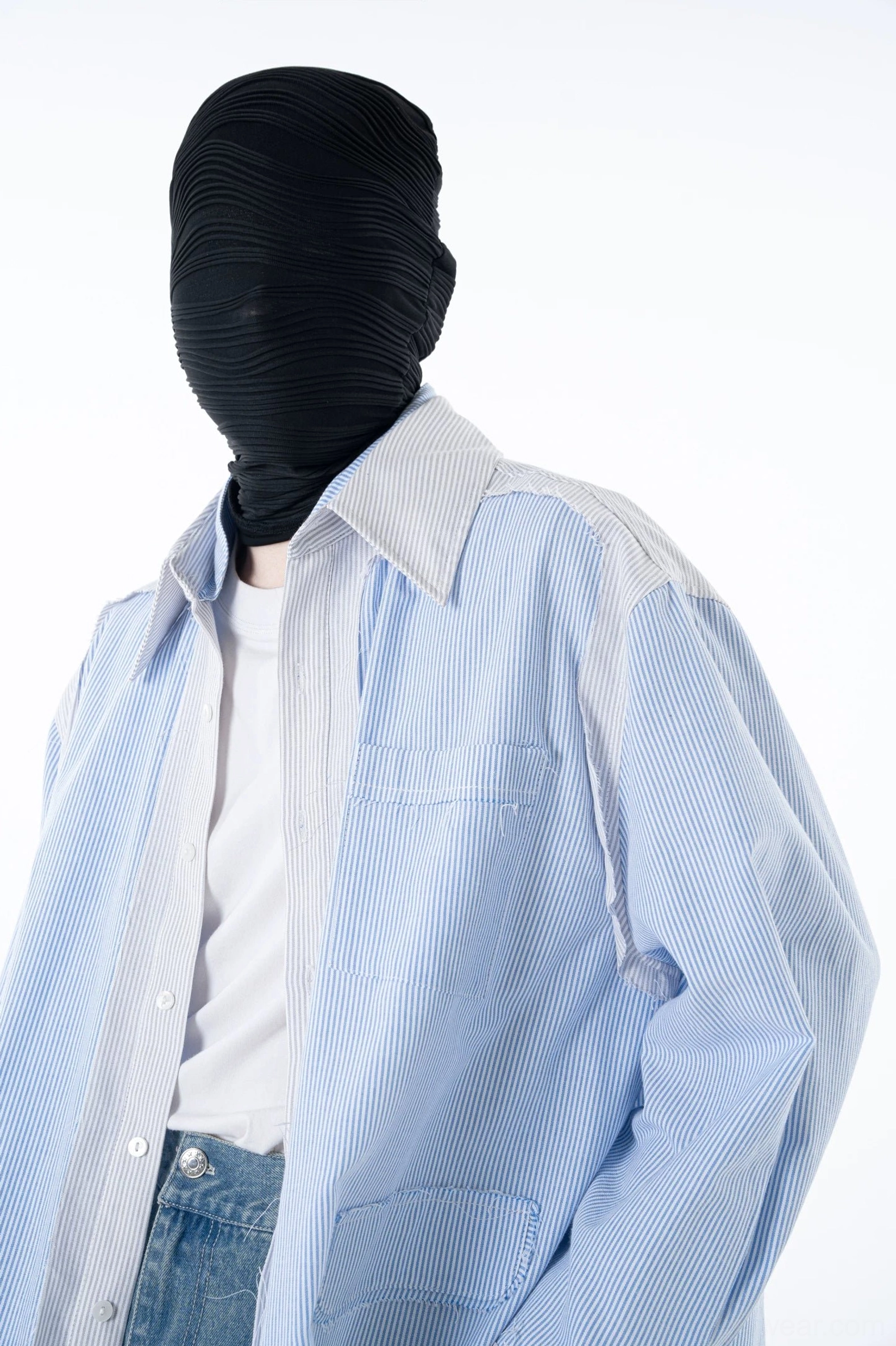 Upper-body close-up of a blue pinstripe overshirt with subtle vertical stripes contrast white button placket and relaxed tailored fit