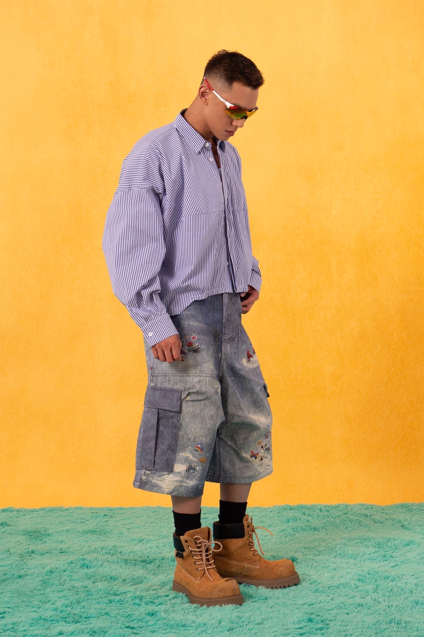 Blue and white pinstripe oversized poplin shirt with a loose full-length fit styled with denim cargo shorts