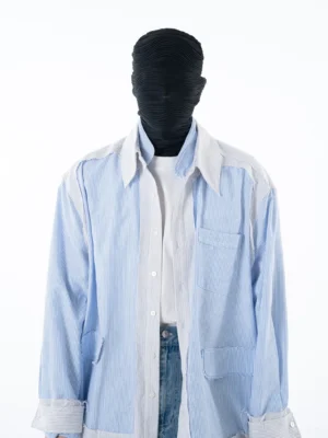 Front full-body view of a relaxed blue pinstripe shirt jacket with contrast white panels chest patch pocket and oversized Korean streetwear silhouette