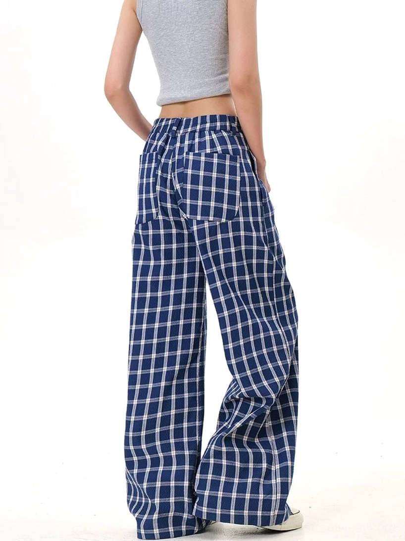 Back view of blue and white plaid high-waisted wide-leg pants with rear patch pocket and flowing relaxed leg shape