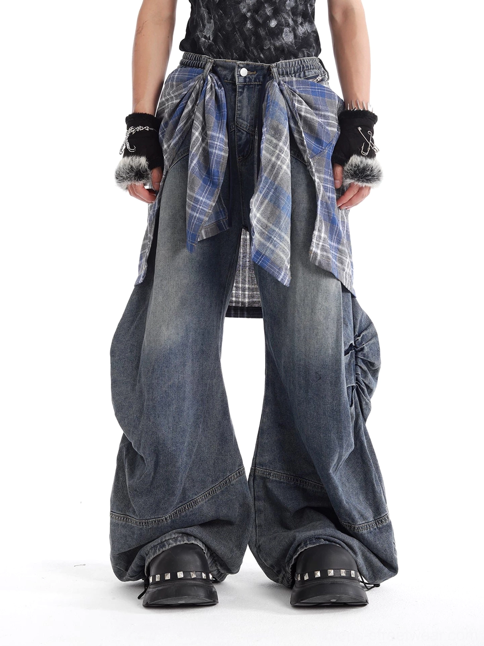 Front view of oversized blue plaid layered balloon jeans with wide legs, washed denim, tartan waist panel, and punk streetwear styling