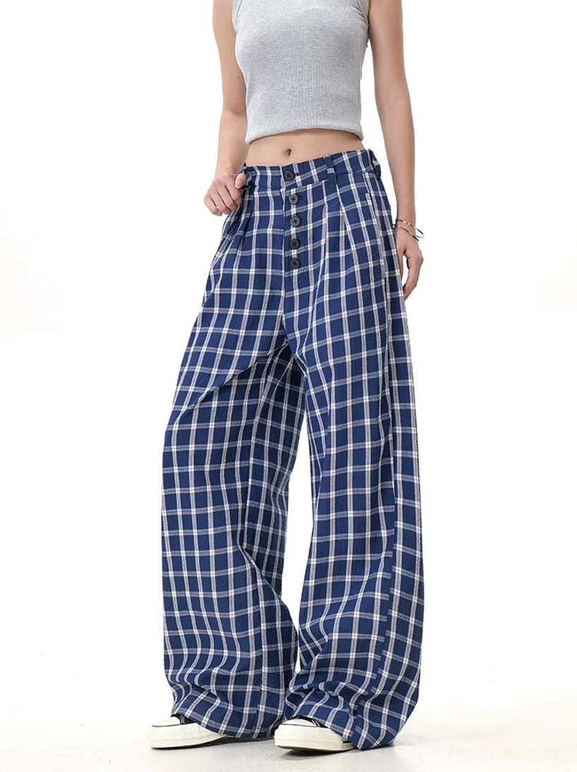 Blue plaid wide-leg streetwear trousers with front button placket, side pockets, and relaxed flowy silhouette shown from the side