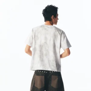 Back view of an off-white tie-dye blue script floral cotton graphic tee showing the clean unprinted back and relaxed short-sleeve streetwear fit