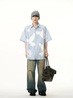 Blue and white striped dove print short sleeve button-up shirt full front outfit with distressed wide-leg jeans and leather tote bag