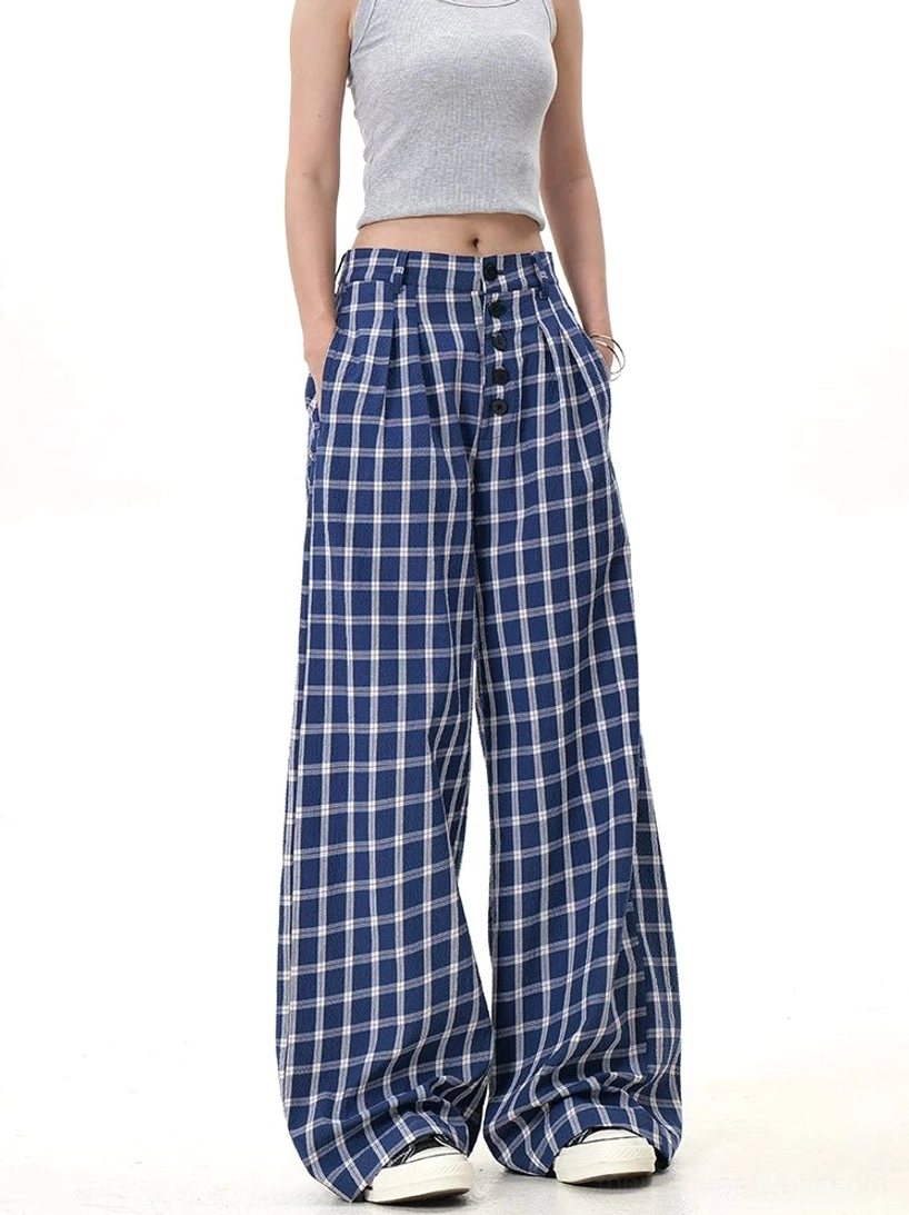 Blue and white checkered wide-leg pants with side pockets, button fly, and relaxed draped silhouette shown from a three-quarter angle
