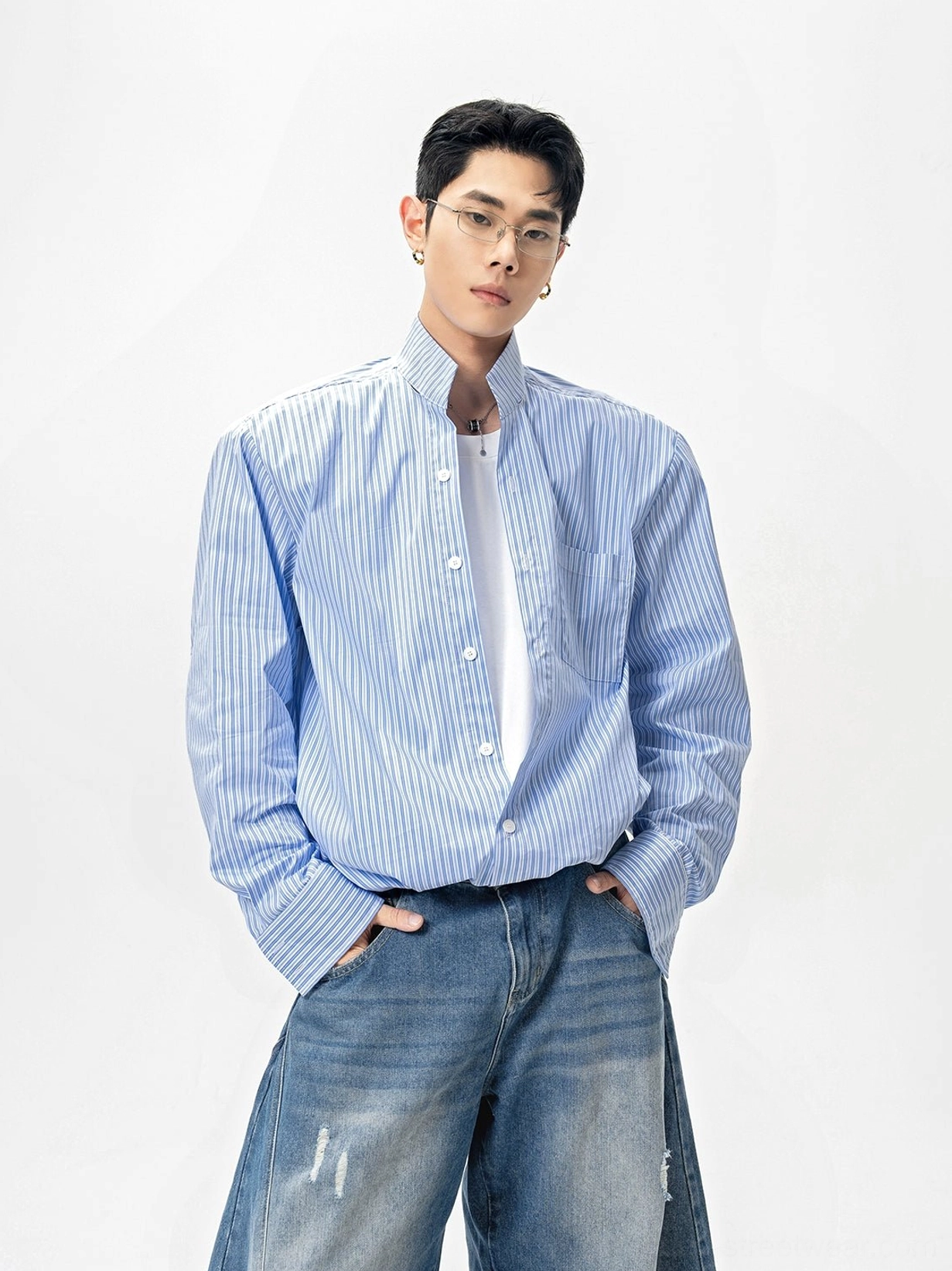 Blue and white pinstripe oversized stand collar shirt with chest pocket and distressed denim streetwear outfit