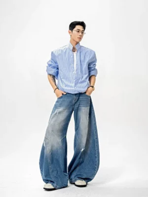 Blue and white vertical pinstripe stand collar shirt styled with white tee and distressed wide-leg jeans