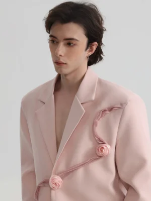 Blush pink rose appliqué oversized suit blazer close-up with asymmetric 3D fabric flowers and ribbon details