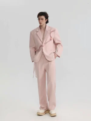 Front view of blush pink rose appliqué oversized suit set with relaxed blazer and wide-leg trousers