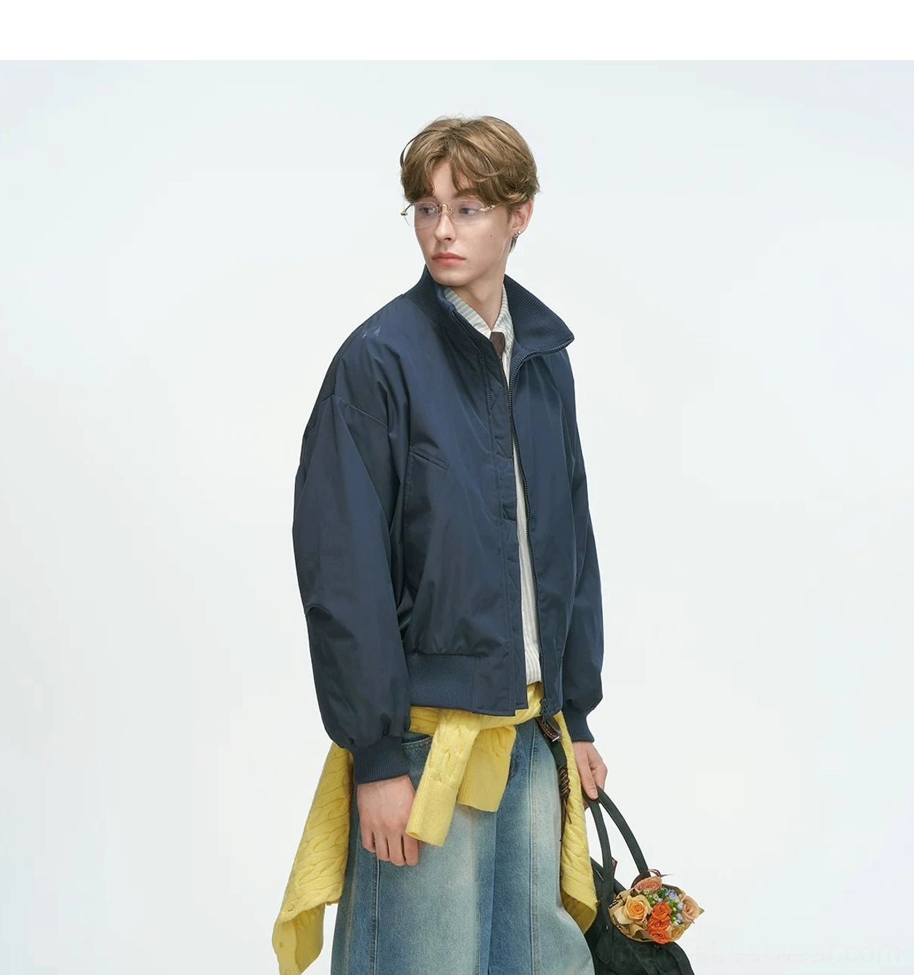 Bomber jacket pocket detail featuring slanted welt pockets design, functional streetwear element showing minimalist aesthetic and construction quality