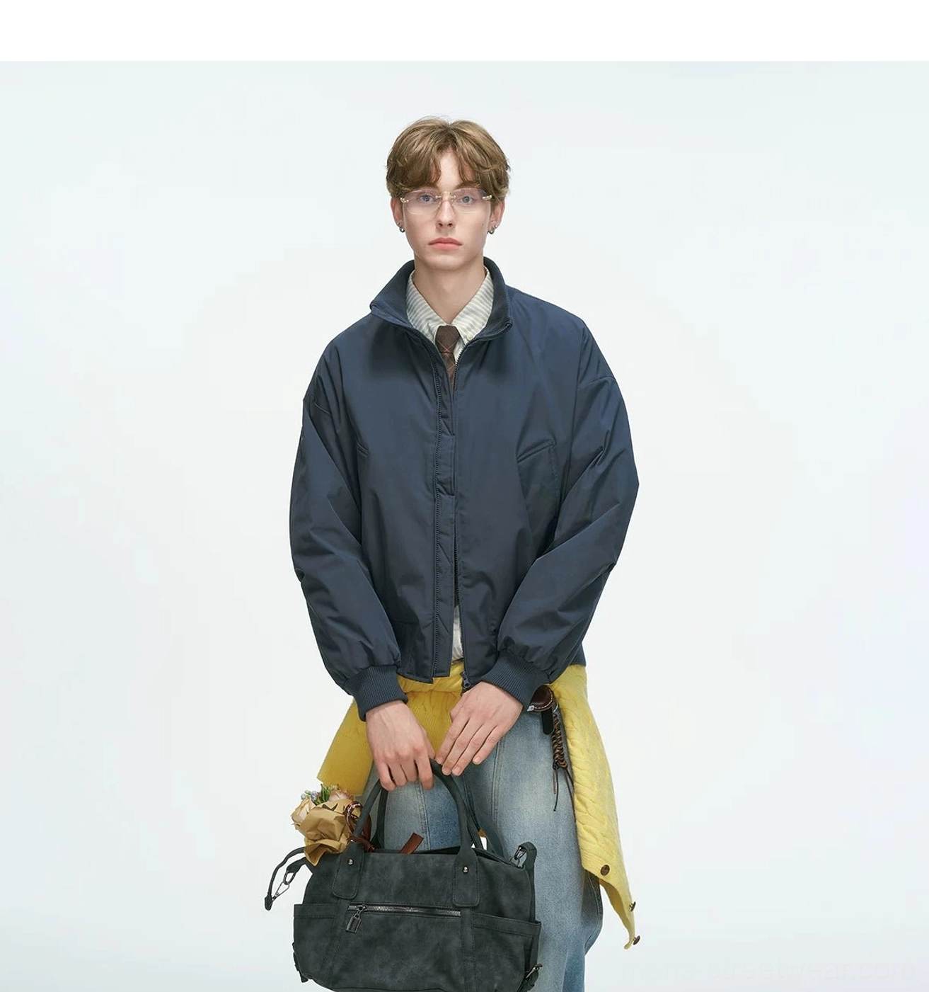 Bomber jacket collar detail showcasing stand collar design and front zip mechanism, clean construction typical of contemporary streetwear essentials