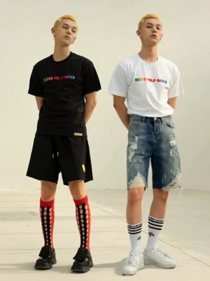 Two male models wearing Boys Help Boys rainbow graphic crewneck T-shirts in black and white with relaxed Korean streetwear styling