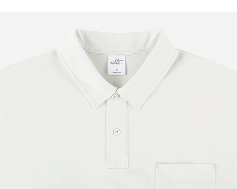 Close up of bright white technical polo shirt collar with two button placket, chest pocket, and neat clean stitching