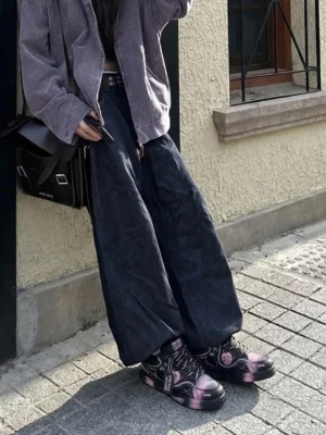 Black graffiti low-top sneakers with pink-purple gradient toe panels shown in a Korean streetwear outfit