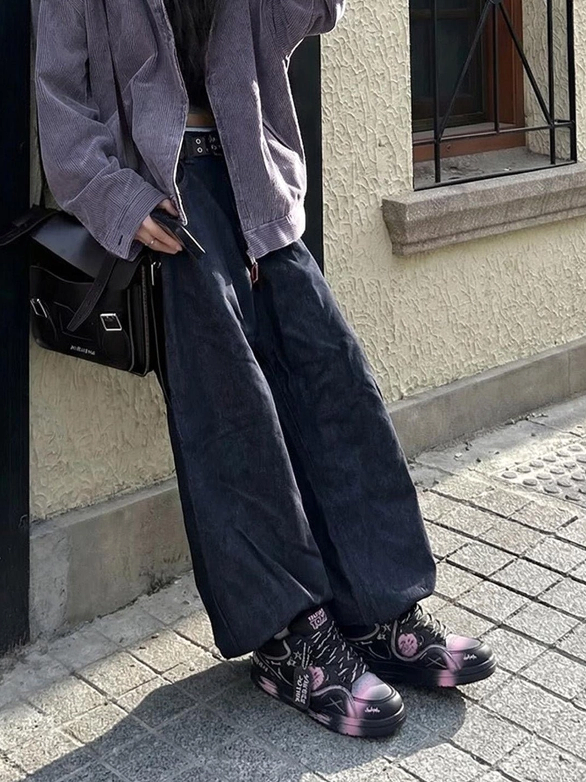 Black graffiti low-top sneakers with pink-purple gradient toe panels shown in a Korean streetwear outfit