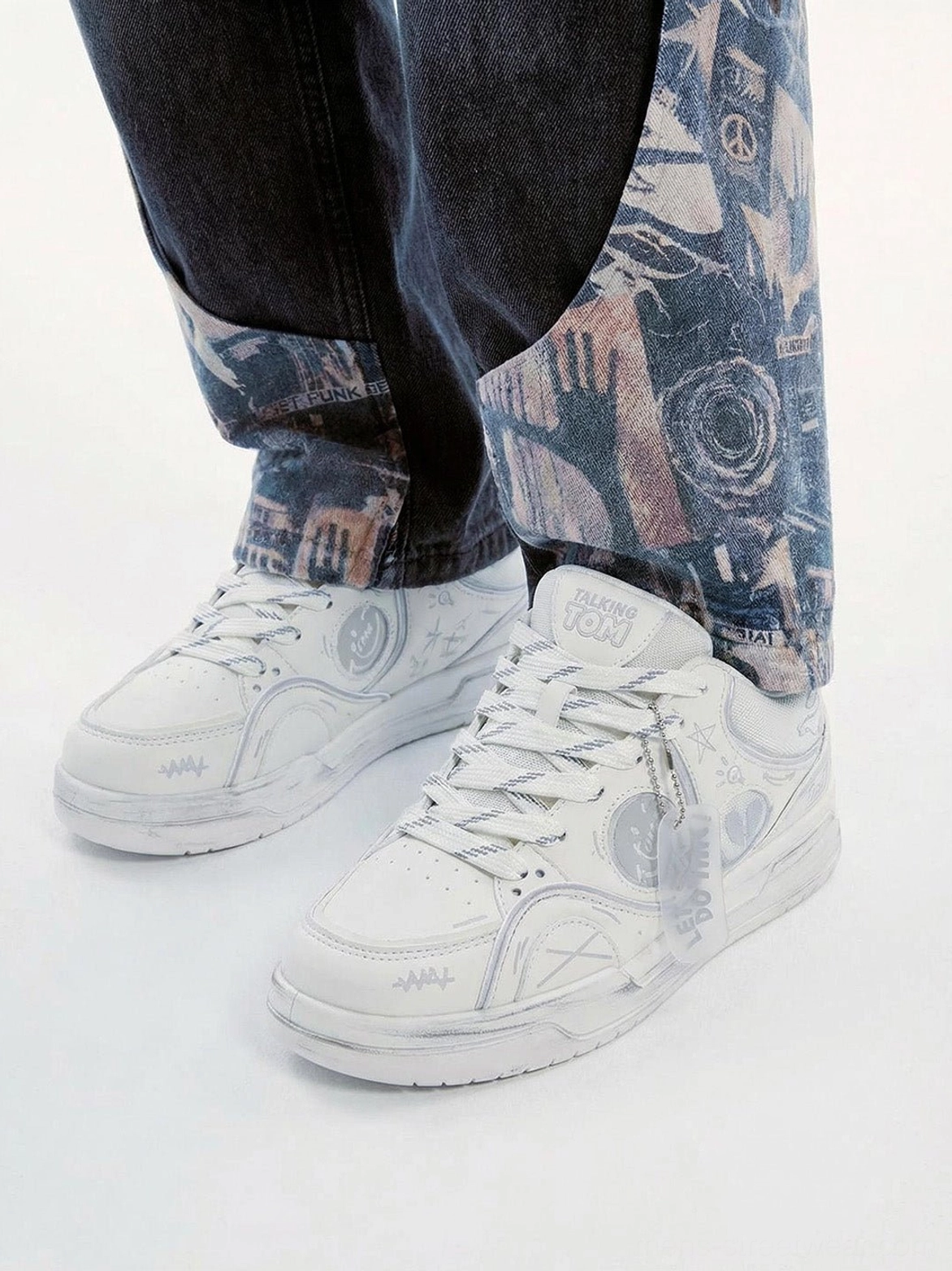 Broken-heart graffiti low-top sneakers with contrast panels and chunky streetwear-inspired sole