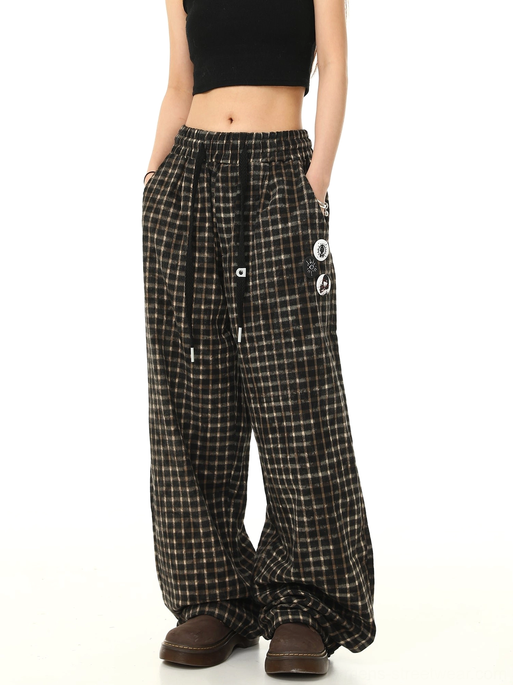 Back three-quarter view of relaxed brown black check track pants with high-rise elastic waistband and wide legs