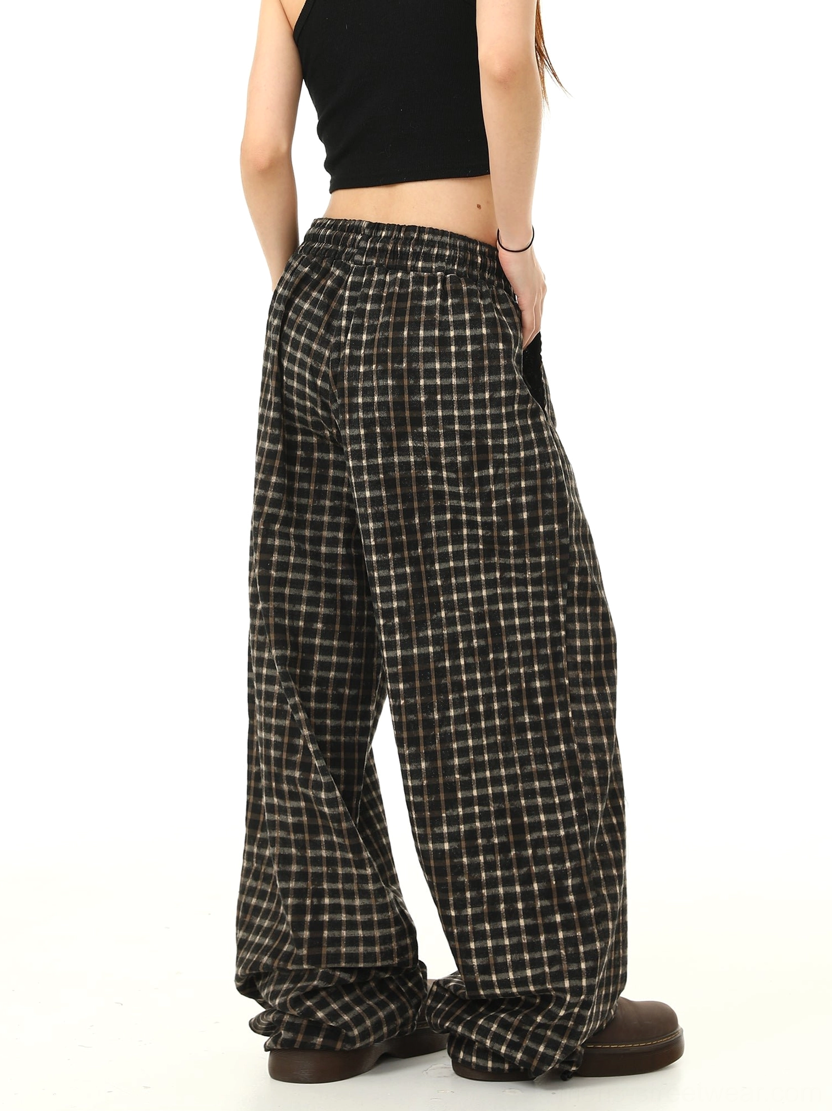 Rear side view of brown black check wide leg track pants showing elastic back waistband and full coverage check fabric