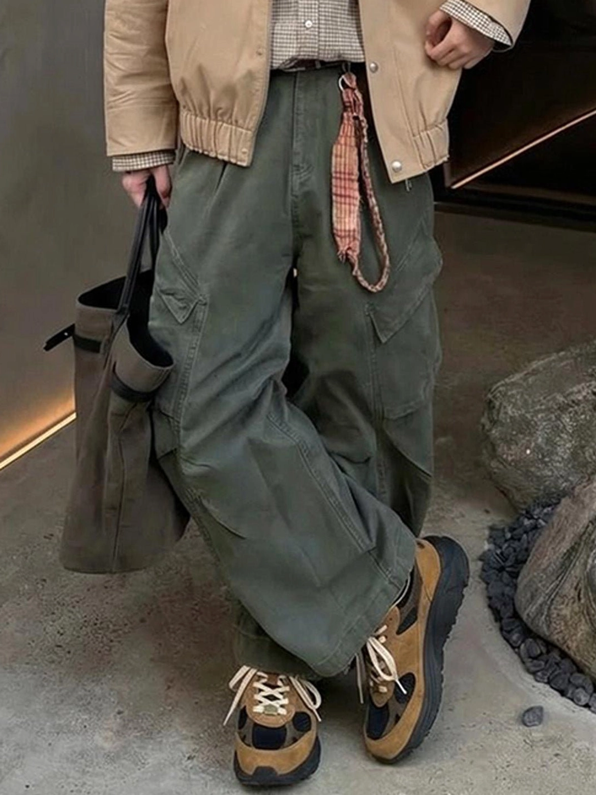 Brown and black distressed trail runner sneakers styled with earth-tone casual streetwear clothing