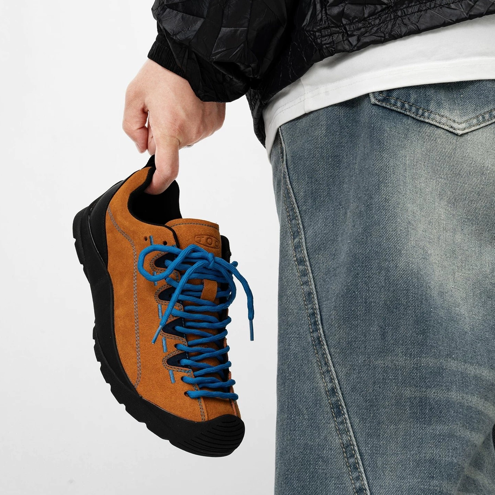 Brown brushed suede trail sneaker with bright blue laces black rubber toe cap and lightweight outdoor traction sole