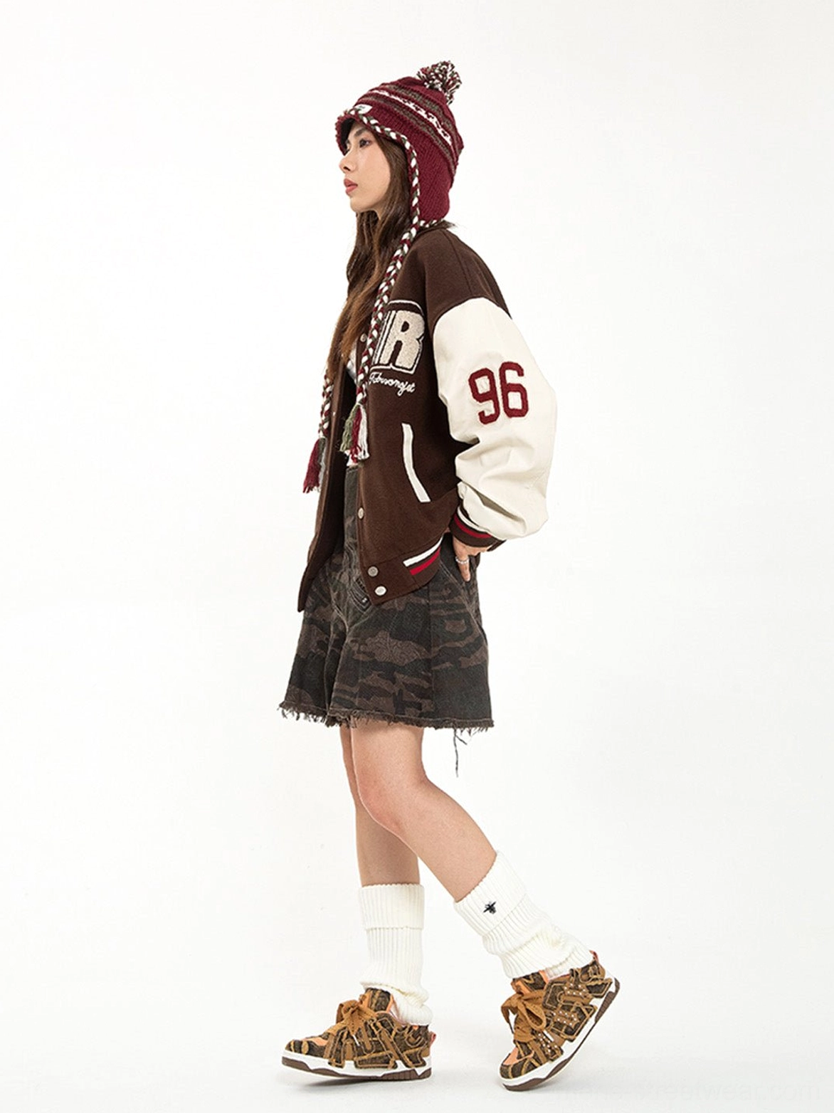 Side view of female streetwear outfit featuring brown camouflage platform skate sneakers with rivet detailing